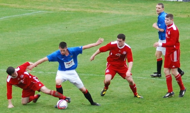 Paul McKenzie nicks the ball from Richie Barr
