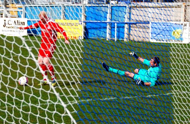 Bo rolls the ball into the net for the fourth