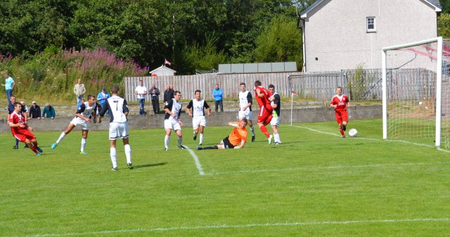 Camerom Marlow (far left) drills the ball goalward with Aaron Connolly in support
