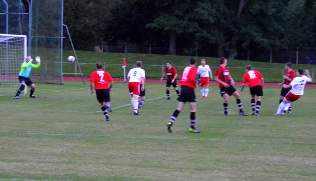 Alain Kinney (far right) lashes home a late equaliser